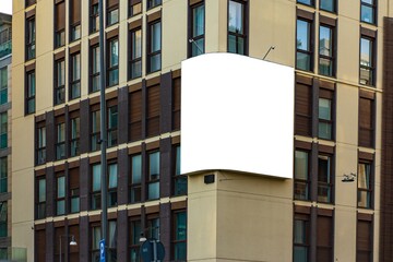 White advertising wall on the corner of an office building in Milan.