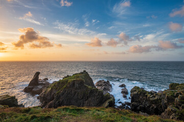 Beautiful dramatic Summer dawn over Lizard Point in Cornwall UK with lovely glowing sky and clouds