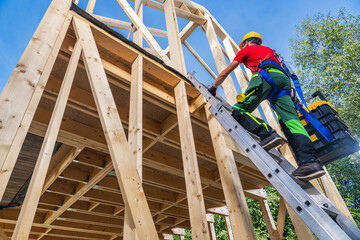 Construction Worker Climbing to Second Level Using Ladder