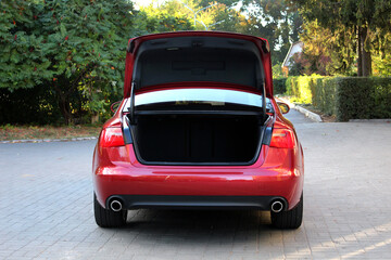 Modern red car with open empty trunk. Modern sedan car open trunk. Red Car boot is open. Limusine open empty trunk.