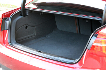 Modern red car with open empty trunk. Modern sedan car open trunk. Red Car boot is open. Limusine...