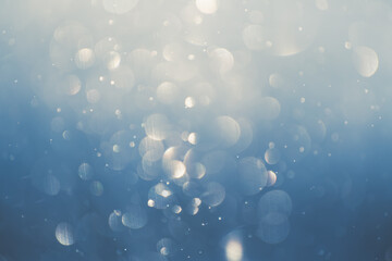 Glowing bokeh abstract background.. Blurred snowflakes in winter forest.
