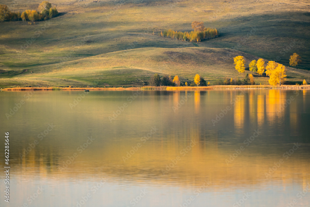Wall mural lake in the autumn mountains. yellow trees and mountains are reflected in the water. - Wall murals