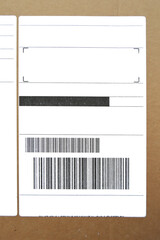 Brown and beige cardboard paper mail envelope on sticky barcodes