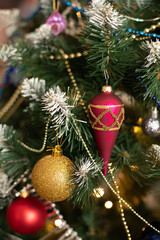 Red and golden baubles on christmas tree for background. New Year concept.