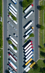 aerial drone view of parking with trucks and trailers near motorway. rest place for trucks and...