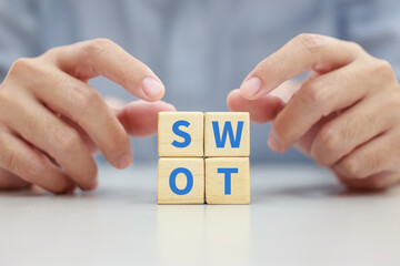 Concept of SWOT analysis and business strategy planning technique. Strengths, weaknesses, threats and opportunities of company. SWOT symbol on wooden cube block. - obrazy, fototapety, plakaty
