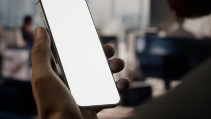 CU Black African-American male using a phone in a busy office