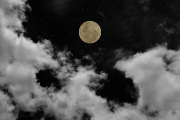 Full moon on the sky with clouds.