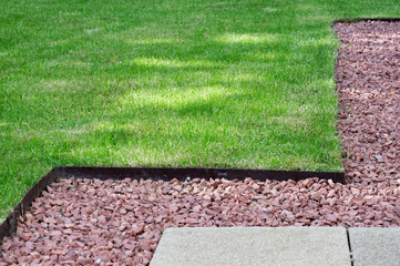 Lawn edging made of metal showing straight and neat finish - obrazy, fototapety, plakaty