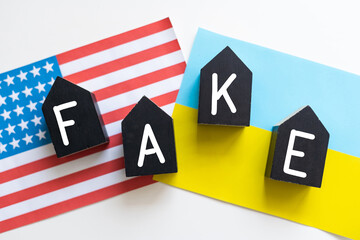 A Fake News pin badge pictured over the flag of the United States of America.
