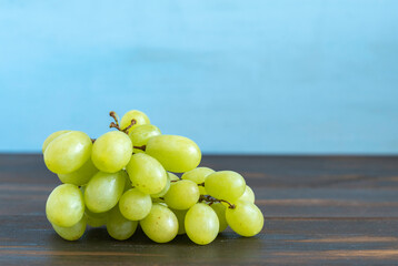 Fresh grapes on wooden background with copy space.