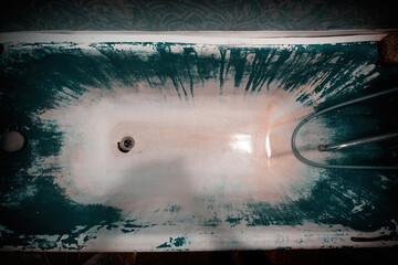 Old bathroom with cast-iron bathtub blue paint smudges like from horror movie