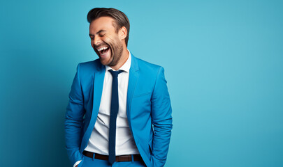 40 years old happy handsome man, smiling and laughing, wearing suit. Bright solid blue background - obrazy, fototapety, plakaty