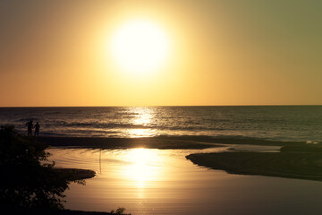 Ocean waves crash at a Pacific Ocean sunset