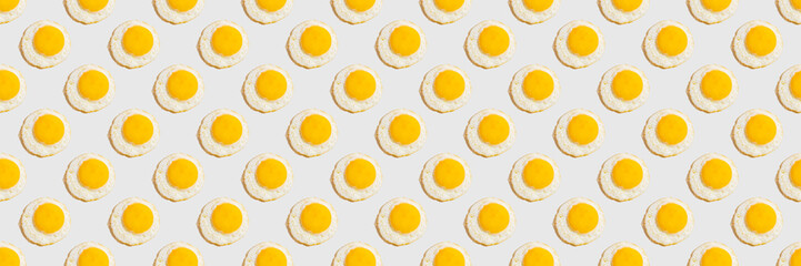 Seamless pattern with sunny side up egg on yellow background. Food banner.