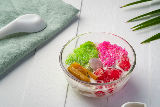 Chilled sweet vermicelli in coconut milk (salim).Thai Dessert mixed sweet noodles,boiled pumpkin,Sweet waterchestnuts and nipa palm fruit in glass bowl