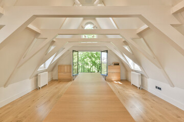 an empty room with wood flooring and skylights in the middle of the room there is a large window...
