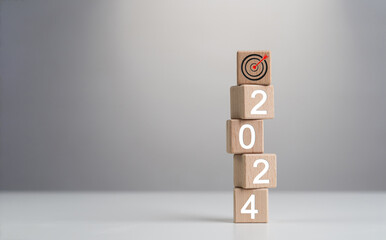 2024 Goals of business or life. Wooden cubes with 2024 and goal icon on smart background. Starting...