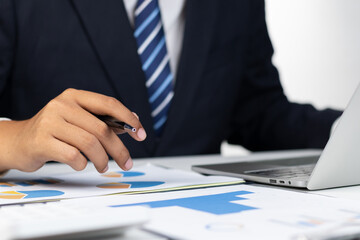 Businessman analyzing financial data for growth, read and write company performance reports, Financial analysis and planning and strategies to maximize sales profits.