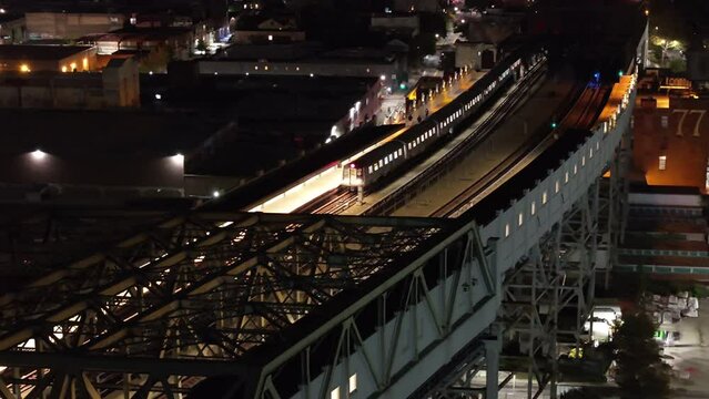 Drone footage of an above ground subway at night
