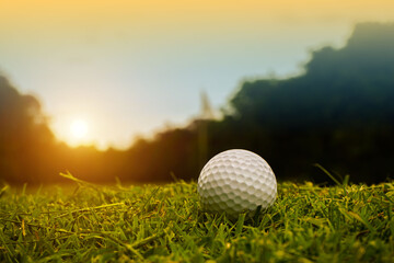 Golf ball is on a green lawn in a beautiful golf course with morning sunshine. Ready for golf in the first short.