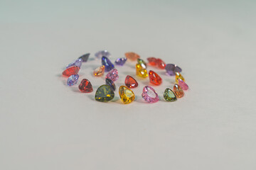 .Heart-shaped gemstones in various colors are set in a circle..Natural stone minerals that are...