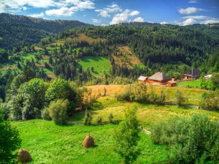Picturesque village houses in the mountains. Old stone farmhouse with tile roof.