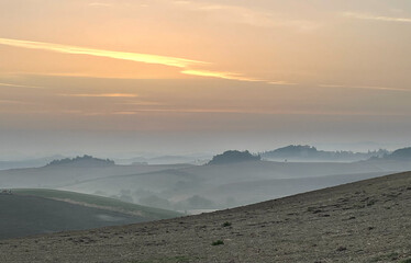 Sunrise with fog in the rolling hills of Tuscany, background, texture