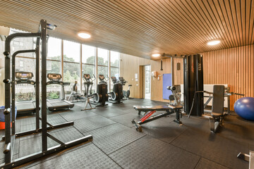 the inside of a home gym with weights, equipment and an exercise mat on the floor in front of the...