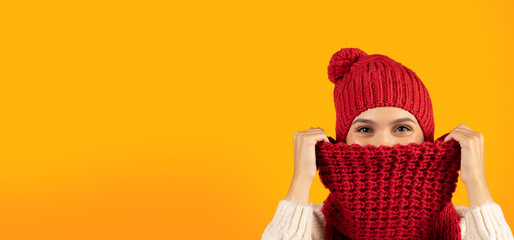 Woman Wearing Hat And Scarf Hiding From Winter Cold, Studio