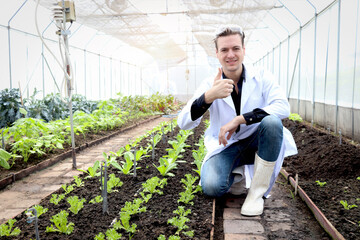 Botanist scientist man in lab coat working on experimental plant plots, male biological researcher...