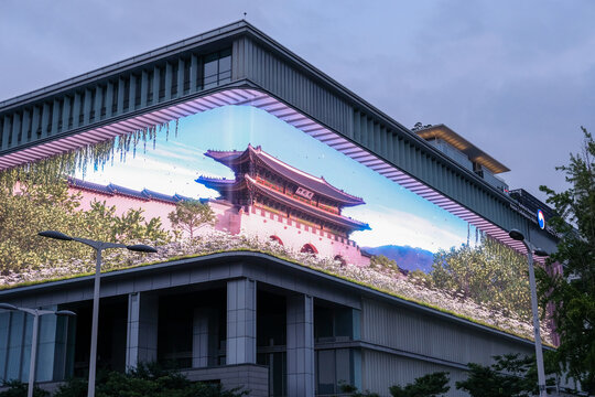 Seoul, South Korea - 11 July 2022: a large-scale LED panel displaying media art on Seoul museum's building facade, showing graphic of Gyeongbokgung palace