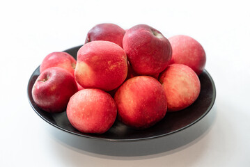 Ripe apples on a black plate