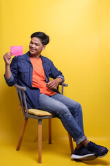 Full length photo of optimistic guy wear casual clothes hold smartphone and comment shape for social media advertisement