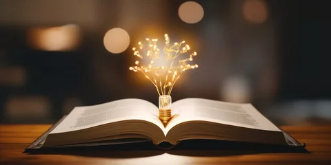 Fotobehang an incandescent lamp glows above an open book. generative AI © Nanda
