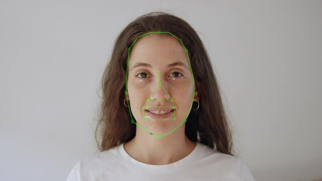 Ai face detection tracking and recognition algorithm on young woman face. Artificial intelligence A.I. recognizing and identifying facial features and gestures of female looking at camera frontal