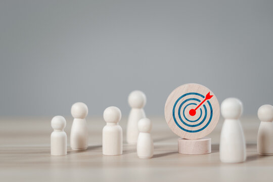Customer relationship management concept. wooden block with target icon linked with human for customer focus group. Data exchanges development and customer service.