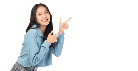 Beautiful young Asian woman pointing up to copy space and looking at camera with smile face and happy Pretty girl act like a satisfied product, use for advertising with isolated on white background