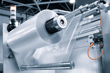 Automatic polyethylene plastic bag production machine with lighting effect. Close-up of the roller...