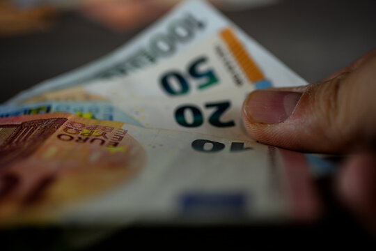 Hand and euro bank notes close up. High quality photo