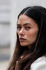 Head-shot of mixed race female model looking at camera.