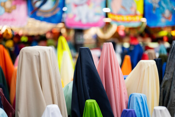 colorful fabrics on hangers in a store