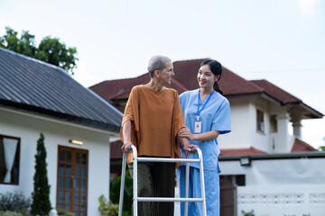 Nurse or caregiver hand on walking frame for support, help or trust moving leg in rehabilitation. Physiotherapy healthcare, Medical caregiver consulting disabled elderly patient at home