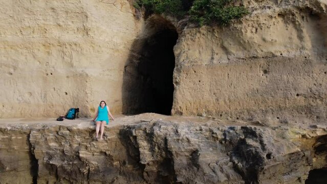 Anzio Italy, May 26 2023: aerial view of the cave with a girl on the edge and the sea