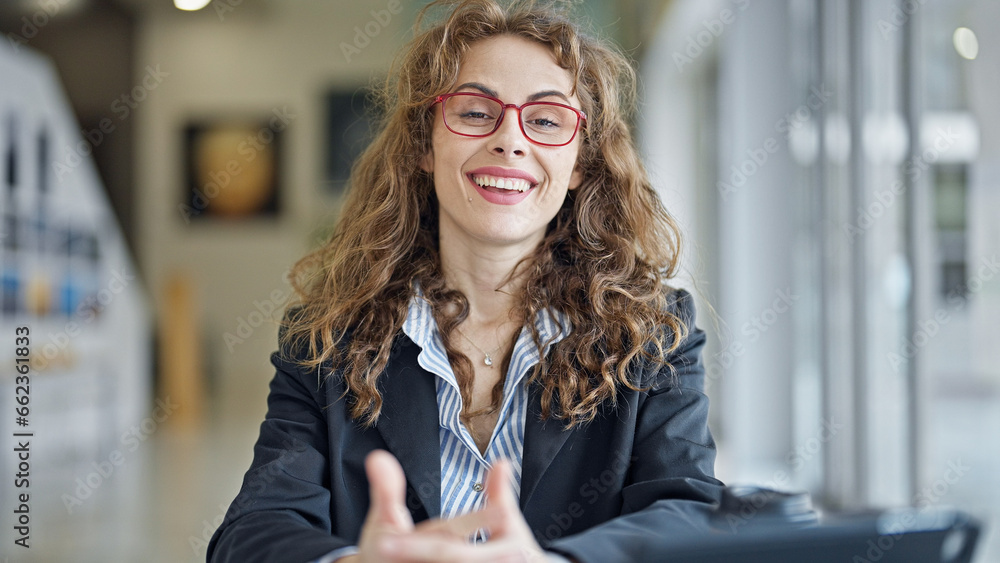 Wall mural Young woman business worker smiling confident speaking at the office