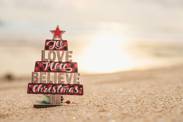 Wooden christmas tree toy on the beach