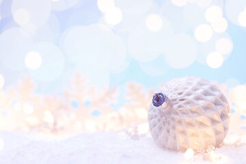 Christmas ball on a snow with decorations and flares