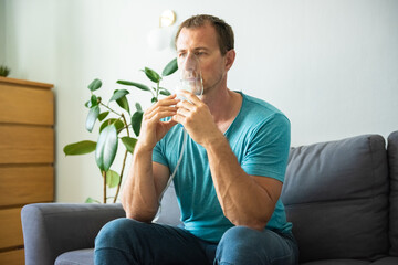 Oxygen Mask For Pulmonary Disease And Fibrosis. Man Inhaling at home