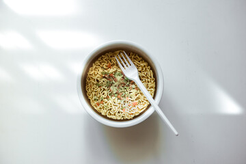 Bowl of instant noodles on white background. Dry Asian Fast Food